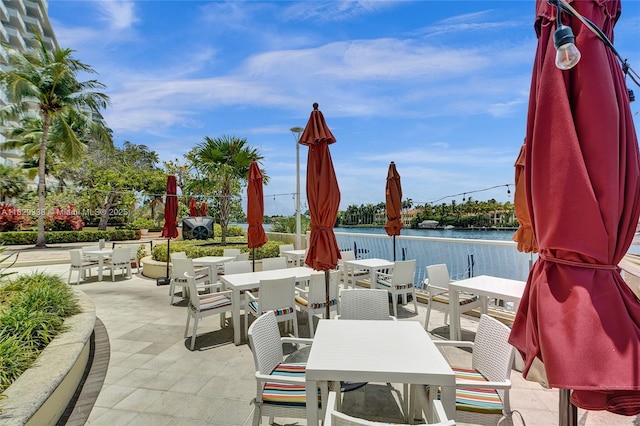 5600 Collins Ave Unit 10L, Miami Beach, FL 33140 - view of patio featuring outdoor dining space and a water view
