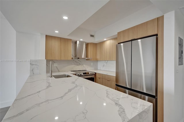 5600 Collins Ave Unit 10L, Miami Beach, FL 33140 - kitchen featuring stainless steel appliances, wall chimney exhaust hood, modern cabinets, light stone counters, and recessed lighting