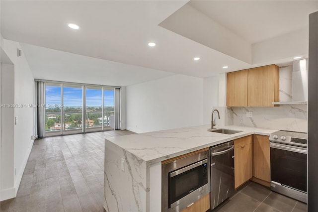 5600 Collins Ave Unit 10L, Miami Beach, FL 33140 - kitchen with appliances with stainless steel finishes, decorative backsplash, a peninsula, light stone countertops, and open floor plan