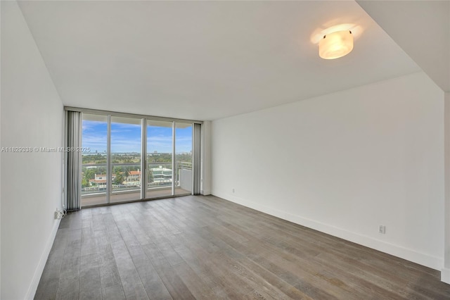 5600 Collins Ave Unit 10L, Miami Beach, FL 33140 - unfurnished room featuring wood finished floors and expansive windows