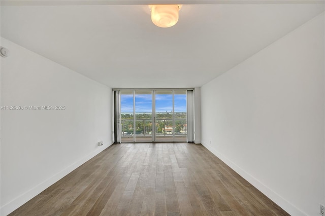 5600 Collins Ave Unit 10L, Miami Beach, FL 33140 - empty room featuring floor to ceiling windows and wood finished floors