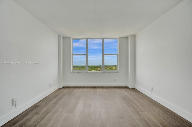 5600 Collins Ave Unit 10L, Miami Beach, FL 33140 - empty room featuring wood finished floors and baseboards