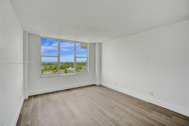 5600 Collins Ave Unit 10L, Miami Beach, FL 33140 - spare room with wood finished floors and baseboards