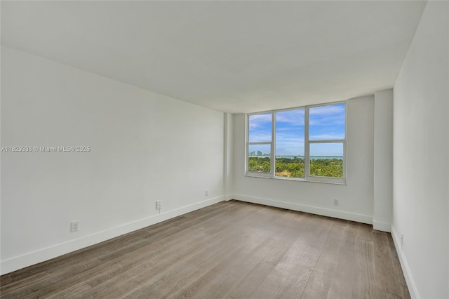 5600 Collins Ave Unit 10L, Miami Beach, FL 33140 - unfurnished room featuring wood finished floors and baseboards