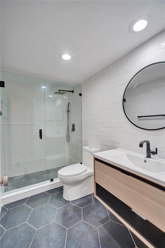 5600 Collins Ave Unit 10L, Miami Beach, FL 33140 - full bath featuring vanity, tile walls, a stall shower, tile patterned flooring, and recessed lighting