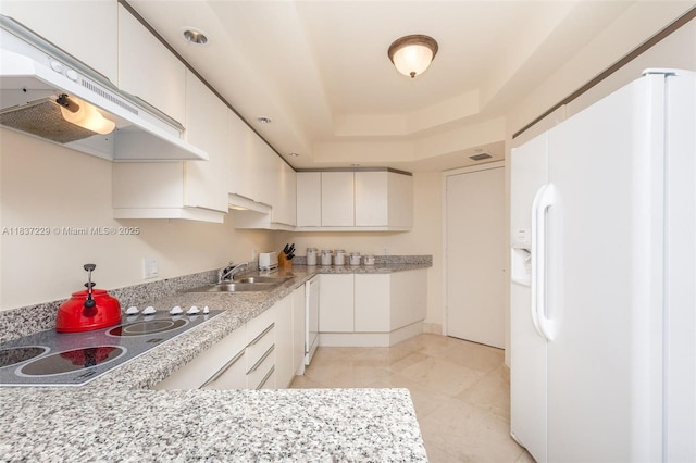 7000 Island Blvd Unit 2504, Aventura, FL 33160 - kitchen with white appliances, light countertops, under cabinet range hood, and white cabinetry