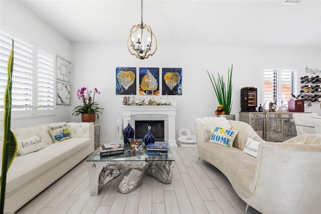 8236 SW 36th St, Miami, FL 33155 - living area with plenty of natural light, a chandelier, wood finished floors, and a glass covered fireplace