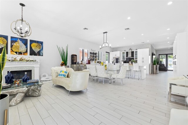 8236 SW 36th St, Miami, FL 33155 - living room featuring a chandelier, a stone fireplace, and recessed lighting