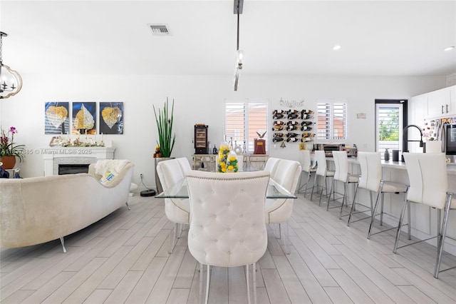 8236 SW 36th St, Miami, FL 33155 - dining room featuring light wood-style flooring, a fireplace, and recessed lighting
