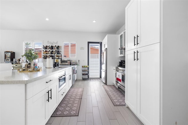 8236 SW 36th St, Miami, FL 33155 - kitchen with a peninsula, glass insert cabinets, stainless steel appliances, white cabinetry, and recessed lighting