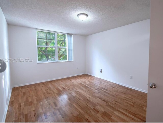 19501 E Country Club Dr Unit 9306, Aventura, FL 33180 - unfurnished room with a textured ceiling and wood finished floors