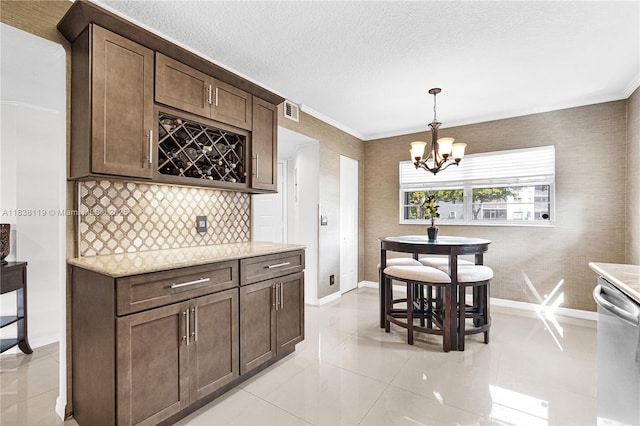 12650 SW 6th St Unit 101K, Pembroke Pines, FL 33027 - kitchen with dishwasher, a chandelier, light tile patterned flooring, tasteful backsplash, and a textured ceiling
