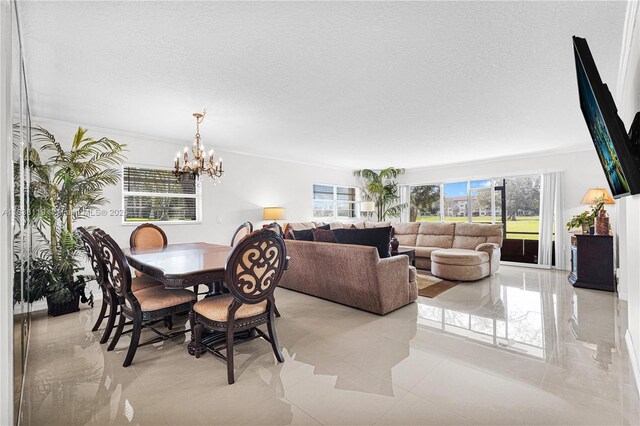 12650 SW 6th St Unit 101K, Pembroke Pines, FL 33027 - dining area featuring a chandelier and a textured ceiling