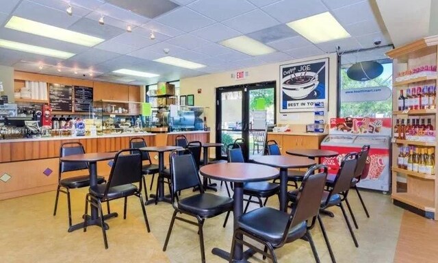 12650 SW 6th St Unit 101K, Pembroke Pines, FL 33027 - dining room featuring a paneled ceiling