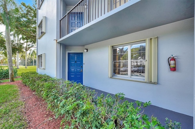 12650 SW 6th St Unit 101K, Pembroke Pines, FL 33027 - view of exterior entry with stucco siding and a balcony