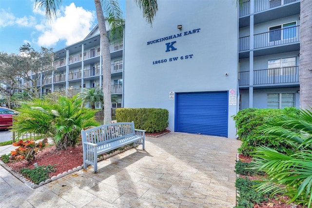 12650 SW 6th St Unit 101K, Pembroke Pines, FL 33027 - view of apartment building / complex featuring a garage