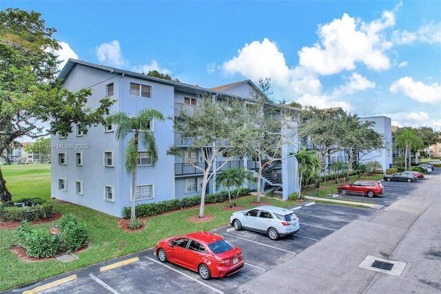 12650 SW 6th St Unit 101K, Pembroke Pines, FL 33027 - view of property with uncovered parking