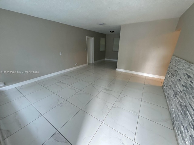 2307 Rodman St, Hollywood, FL 33020 - spare room featuring light marble finish floors and baseboards