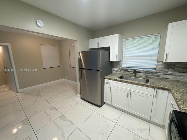 2307 Rodman St, Hollywood, FL 33020 - kitchen with freestanding refrigerator, black stove, light marble finish flooring, and decorative backsplash