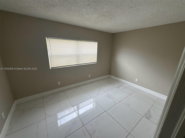 2307 Rodman St, Hollywood, FL 33020 - empty room with light marble finish flooring and a textured ceiling