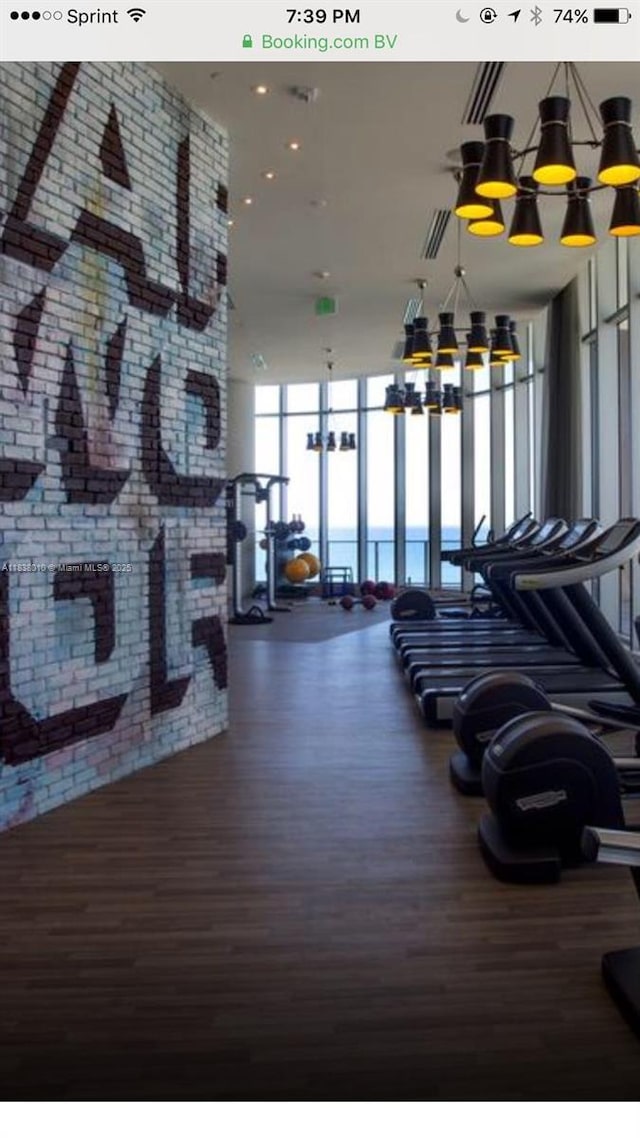 4111 S Ocean Dr Unit 3105, Hollywood, FL 33019 - workout area featuring a chandelier, floor to ceiling windows, and wood finished floors