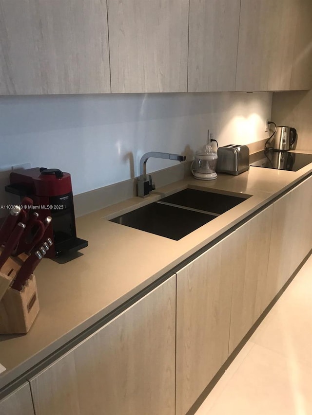 4111 S Ocean Dr Unit 3105, Hollywood, FL 33019 - kitchen with light countertops, black electric cooktop, and modern cabinets