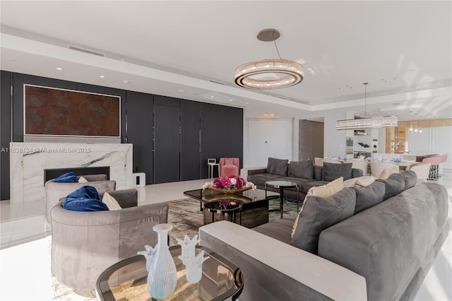 17975 Collins Ave Unit 1202, Sunny Isles Beach, FL 33160 - living room with a chandelier, a premium fireplace, a raised ceiling, and recessed lighting