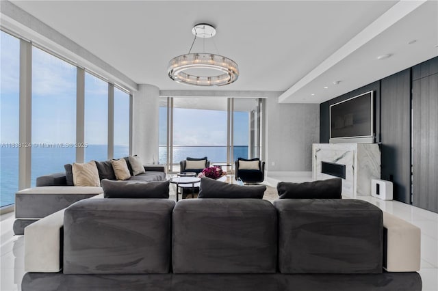 17975 Collins Ave Unit 1202, Sunny Isles Beach, FL 33160 - living area with a water view, a fireplace, floor to ceiling windows, and a chandelier