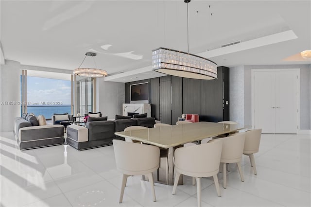 17975 Collins Ave Unit 1202, Sunny Isles Beach, FL 33160 - dining area with a wall of windows, light tile patterned floors, a water view, and a chandelier