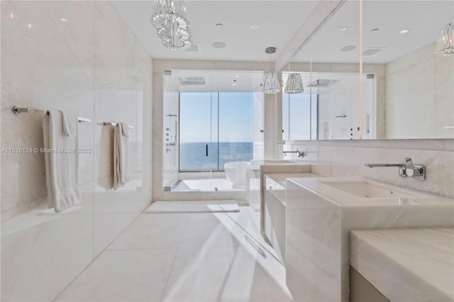 17975 Collins Ave Unit 1202, Sunny Isles Beach, FL 33160 - full bathroom featuring vanity, a chandelier, a stall shower, a soaking tub, and tile patterned flooring