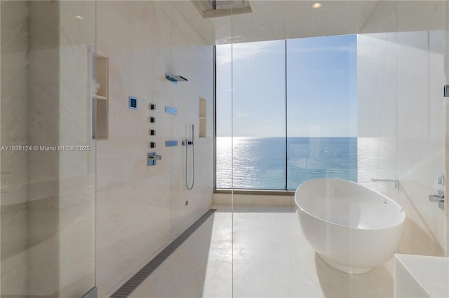 17975 Collins Ave Unit 1202, Sunny Isles Beach, FL 33160 - bathroom featuring a walk in shower, a freestanding bath, a water view, tile patterned floors, and recessed lighting