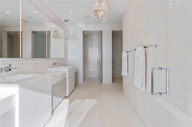 17975 Collins Ave Unit 1202, Sunny Isles Beach, FL 33160 - bathroom with tile walls, double vanity, a stall shower, tile patterned flooring, and a chandelier