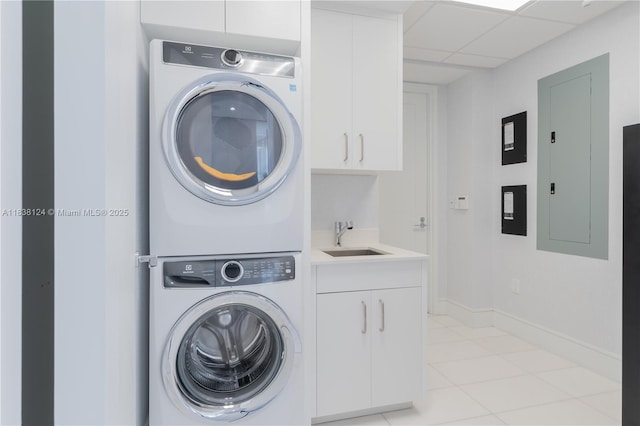 17975 Collins Ave Unit 1202, Sunny Isles Beach, FL 33160 - washroom featuring stacked washing machine and dryer, cabinet space, light tile patterned flooring, and electric panel
