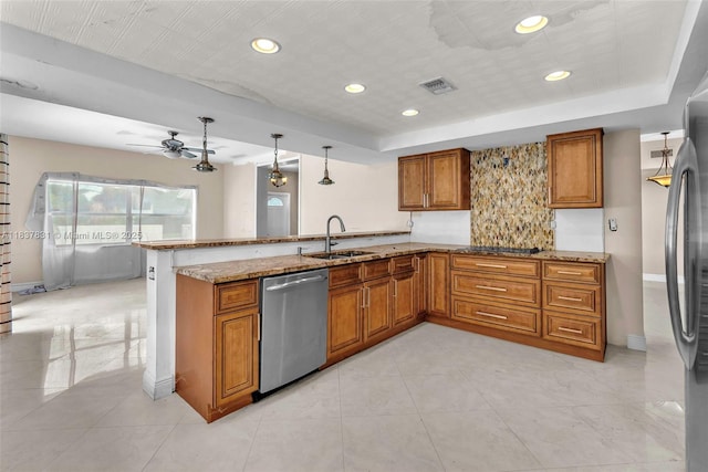 911 Mockingbird Ln, Plantation, FL 33324 - kitchen with appliances with stainless steel finishes, brown cabinetry, a peninsula, a tray ceiling, and recessed lighting