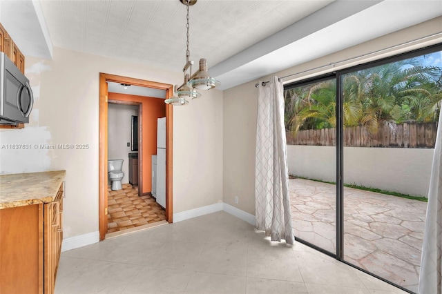911 Mockingbird Ln, Plantation, FL 33324 - unfurnished dining area with baseboards and light tile patterned flooring