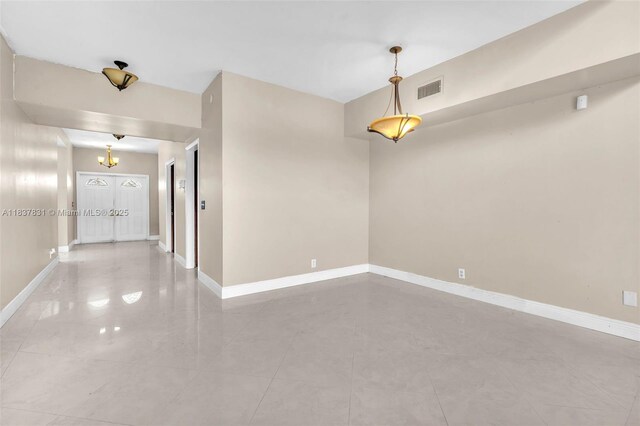 911 Mockingbird Ln, Plantation, FL 33324 - unfurnished room with baseboards and a chandelier