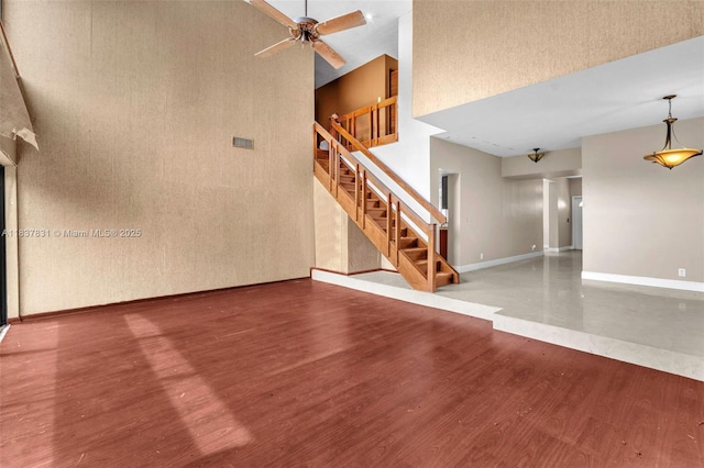 911 Mockingbird Ln, Plantation, FL 33324 - unfurnished living room with a towering ceiling, wood finished floors, stairway, and ceiling fan