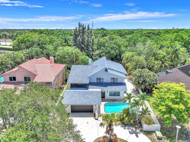 911 Mockingbird Ln, Plantation, FL 33324 - view from above of property featuring a pool and a heavily wooded area