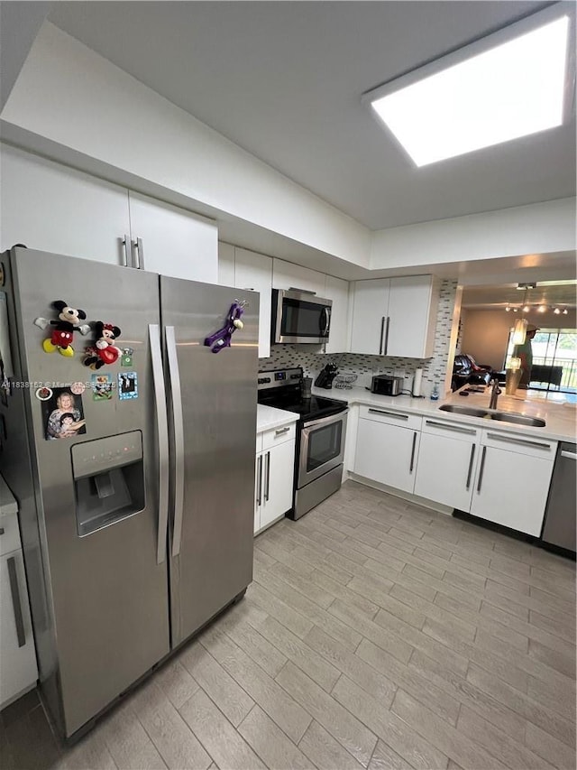 16171 Blatt Blvd Unit 104, Weston, FL 33326 - kitchen featuring stainless steel appliances, light countertops, and white cabinetry