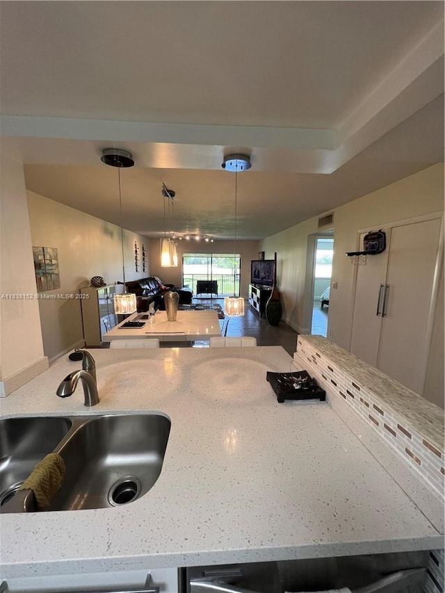 16171 Blatt Blvd Unit 104, Weston, FL 33326 - kitchen with light stone counters and pendant lighting