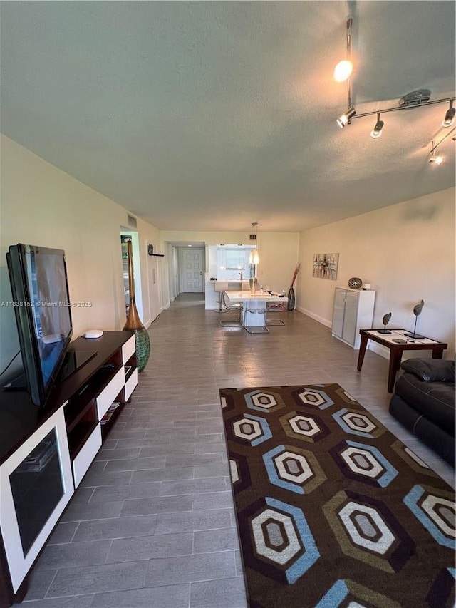16171 Blatt Blvd Unit 104, Weston, FL 33326 - living room featuring baseboards and a textured ceiling