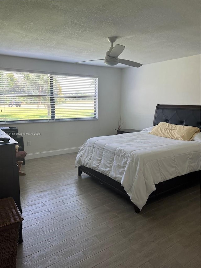 16171 Blatt Blvd Unit 104, Weston, FL 33326 - bedroom featuring wood finished floors, a textured ceiling, and a ceiling fan