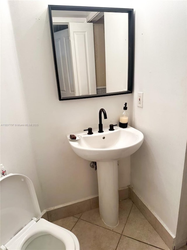 2351 Douglas Rd Unit 702, Miami, FL 33145 - half bathroom with baseboards and tile patterned flooring