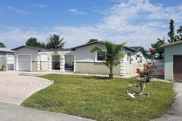 7745 Harbour Blvd, Miramar, FL 33023 - ranch-style home with stucco siding, an attached garage, a front lawn, and decorative driveway