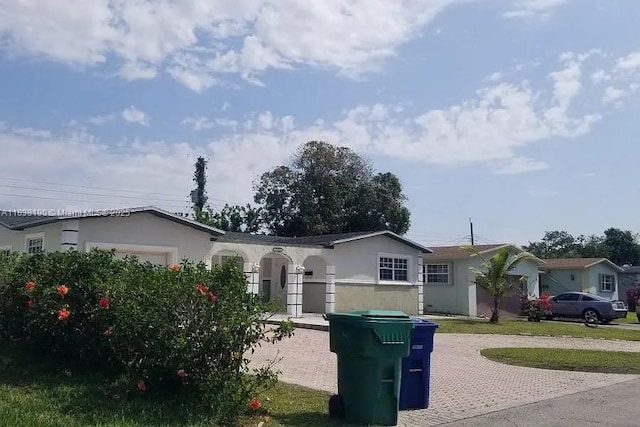 7745 Harbour Blvd, Miramar, FL 33023 - ranch-style home with an attached garage, stucco siding, and decorative driveway