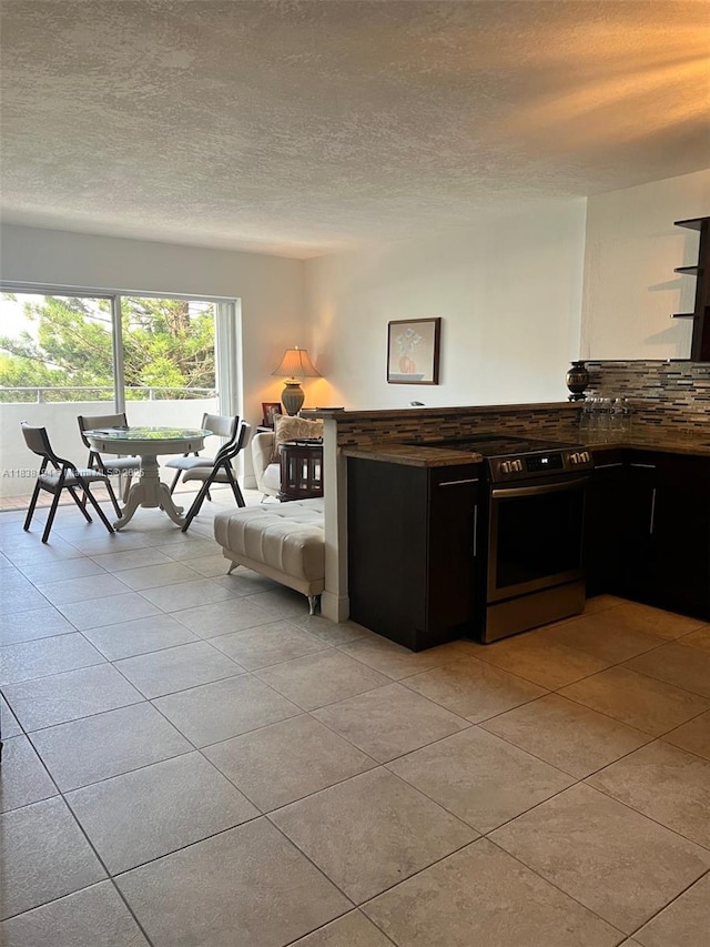 1200 14th St Unit 3C, Miami Beach, FL 33139 - living room featuring light tile patterned floors and a textured ceiling