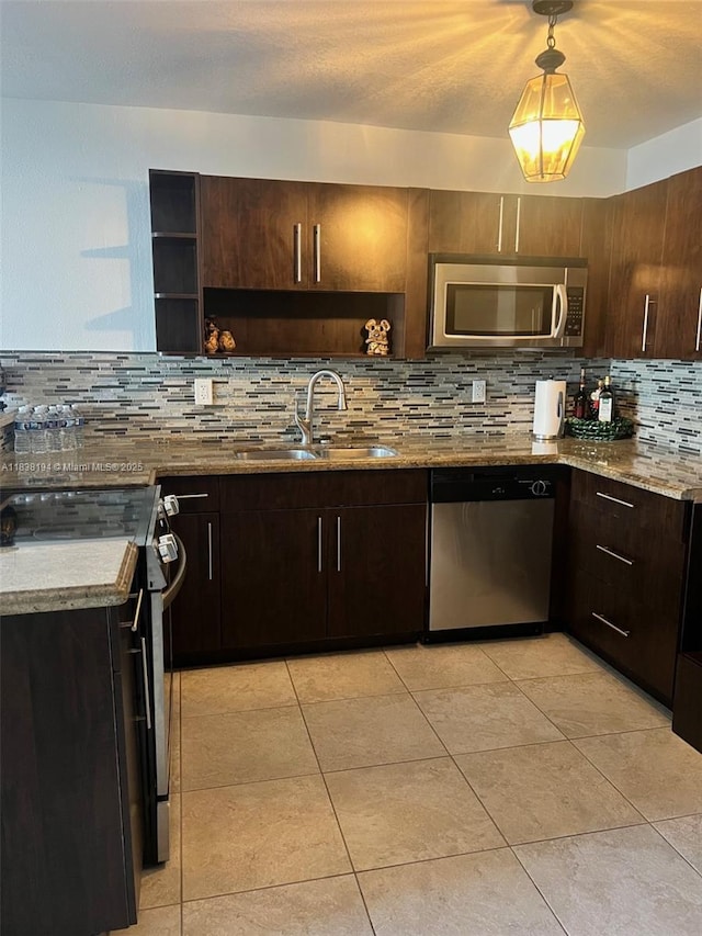 1200 14th St Unit 3C, Miami Beach, FL 33139 - kitchen with appliances with stainless steel finishes, open shelves, backsplash, dark brown cabinetry, and light stone counters