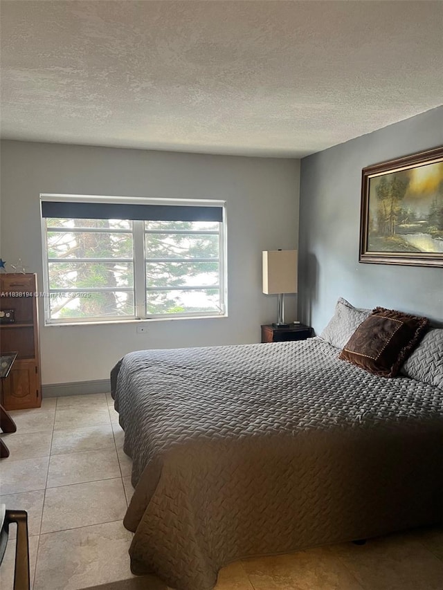 1200 14th St Unit 3C, Miami Beach, FL 33139 - bedroom with a textured ceiling and light tile patterned flooring