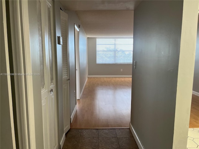 1300 Saint Charles Pl Unit 613, Pembroke Pines, FL 33026 - hallway with baseboards and dark wood-style floors