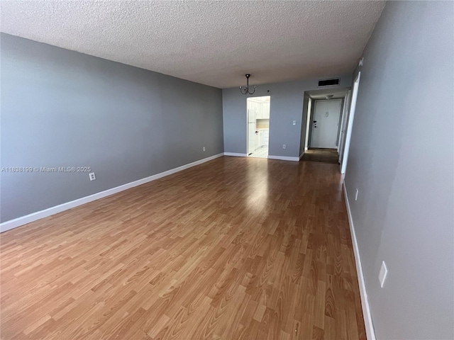 1300 Saint Charles Pl Unit 613, Pembroke Pines, FL 33026 - empty room with a textured ceiling and wood finished floors